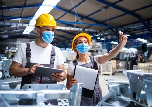 factory-workers-with-face-masks-protected-against-corona-virus-doing-quality-control-of-production-in-factory