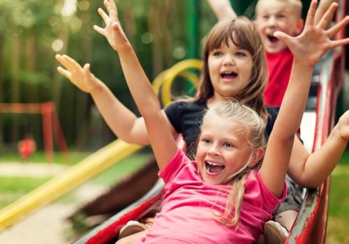 happy-kids-playing-on-slide
