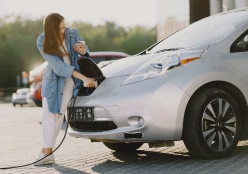 woman-charging-electro-car-electric-gas-station