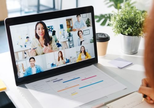 young-asia-businesswoman-using-laptop-talk-colleague-about-plan-video-call-meeting-while-work-from-home-living-room